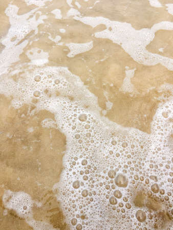 Sea waves reaching lapping to shoreの写真素材