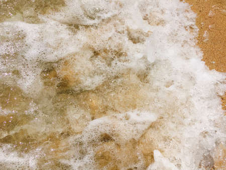 Sea waves reaching lapping to shoreの写真素材