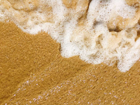 Sea waves reaching lapping to shoreの写真素材