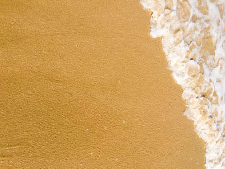 Sea waves reaching lapping to shoreの写真素材