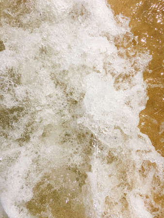 Sea waves reaching lapping to shoreの写真素材