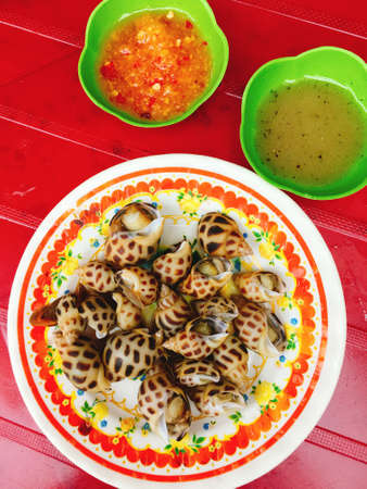 Steamed shells on dish for street food in Vietnamの写真素材
