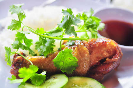 Vietnamese broken rice or com tam with fried chicken legs, pork and herbsの写真素材
