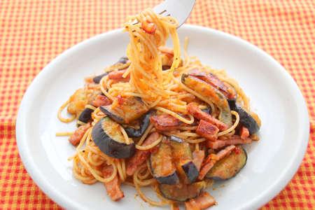 Pasta noodle with eggplant on white dishの写真素材