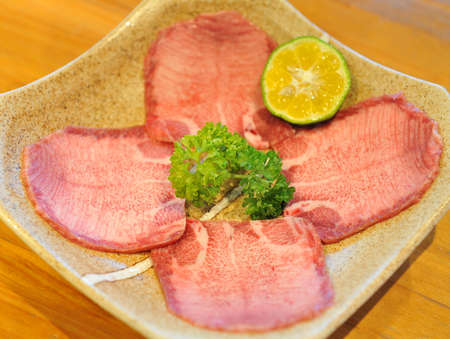 Delicious fresh sliced beef tongue with limeの写真素材