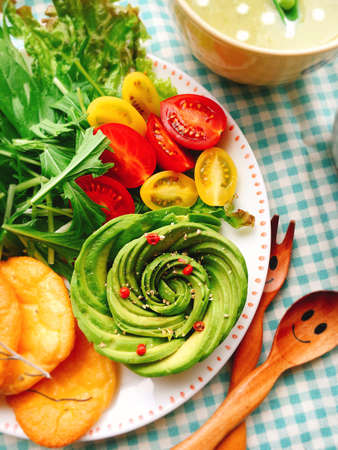 Salad of avocado with tomatoes, fried potatoes and herbsの写真素材