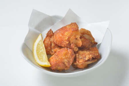 Fried pig's skin with lemon on white backgroundの写真素材