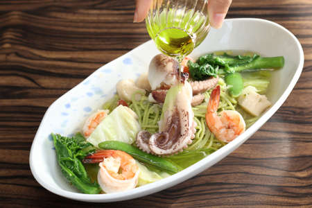 Sauteed octopus with shrimp, noodle, green bean, cabbage and oilの写真素材