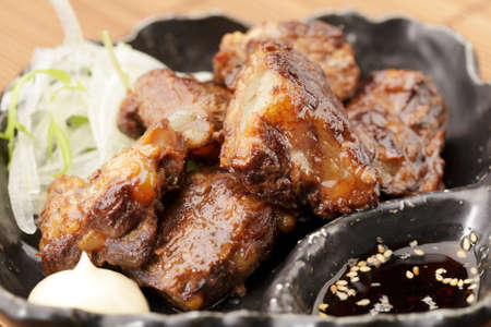 Fried pork ribs in asia on black diskの写真素材