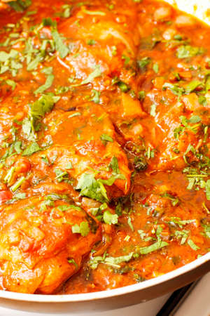 Special fish soup with minced herbs on trayの写真素材