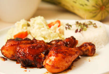 Chicken drumsticks in honey and soy sauce with riceの写真素材