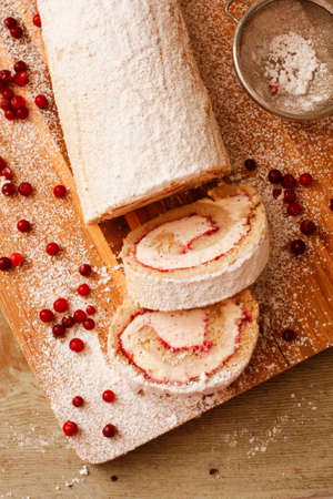 Buckwheat flour rolbiskv?ts with lingonberries on wooden boardの写真素材