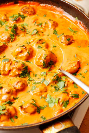 Herring fish balls in tomato and coconut milk sauceの写真素材