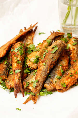 Easy fried pickled herring fish on white platterの写真素材
