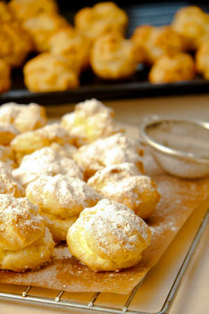 Wind cakes with mascarpone cheese filling in kitchen