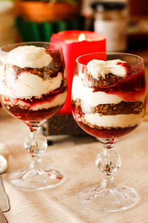 Pumpkin cream and biscuits layered in glasses on the tableの写真素材