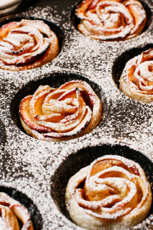Round apple cakes "Rozites" on black panの写真素材