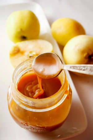 caramel sauce with peach on white platterの写真素材