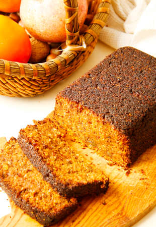 Carrot cake from pea flour on wooden cutting boardの写真素材