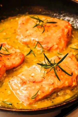 Baked salmon orange and rosemary saucein black panの写真素材