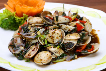 Sauteed clams with soyal sauce and onion on white platterの写真素材