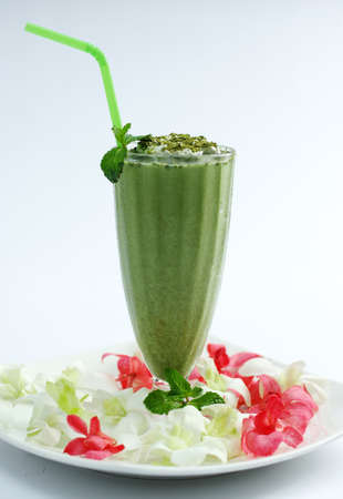Glass of Matcha green tea with vanilla on white backgroundの写真素材