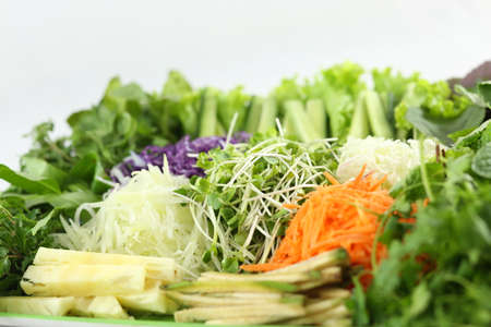 Green fresh vegetables with sprouts, carrot, cucumber and herbsの写真素材