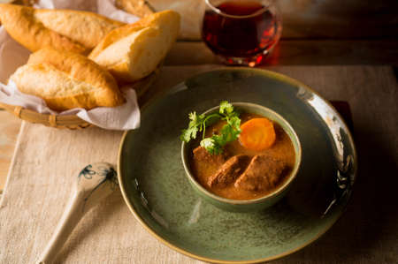 Vietnamese beef stew with carrot and fresh breadの写真素材