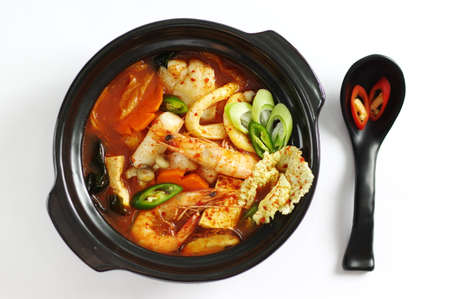 Seafood soup with rice cake and tofu, shrimp, octopus, mushroom and carrotの写真素材