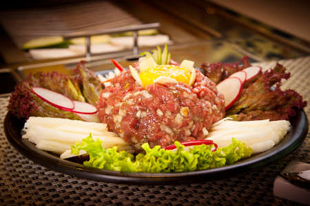 Korean fresh beef with egg, radish, lettuce and vegetablesの写真素材