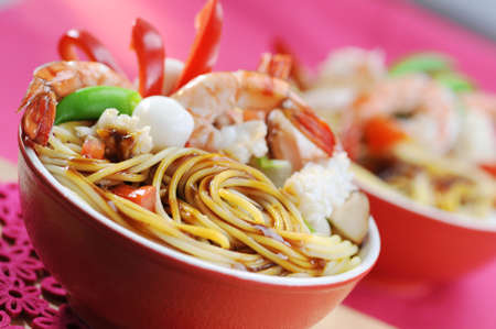 Stir fried spaghetti with seafood shrimp, squid and eggの写真素材