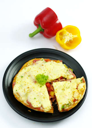 Pork pizza with bell chili on black platterの写真素材