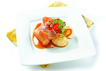 Vietnamese simmered meat with egg on white platterの写真素材