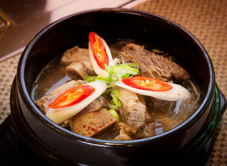 Black stew of pork ribs braised with lotus and onionの写真素材
