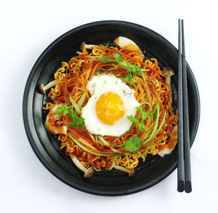 Hot chili ramen noodle with egg and mushroom in black stewの写真素材