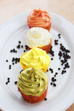Colorful cupcake  with chocolate on white platterの写真素材