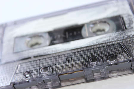 Old audio cassette on white background