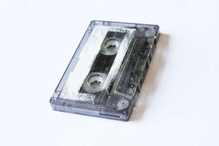 Old audio cassette on white background