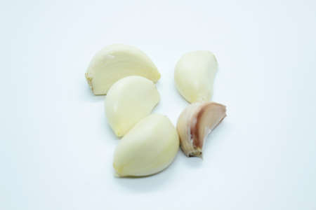 Garlic cloves are located on a white background.の写真素材