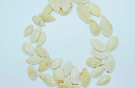 White pumpkin seeds located on a white background