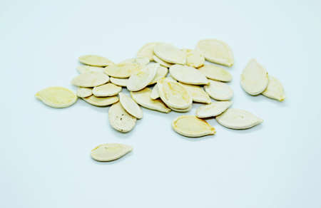 White pumpkin seeds located on a white background