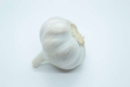 The head of garlic is located on a white background