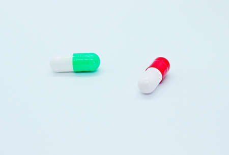 Multi-colored pills are located on a white background