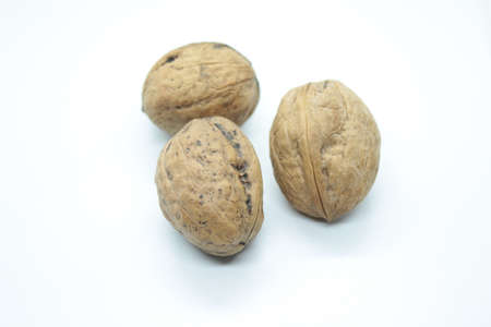 Ripe walnuts located on a white background