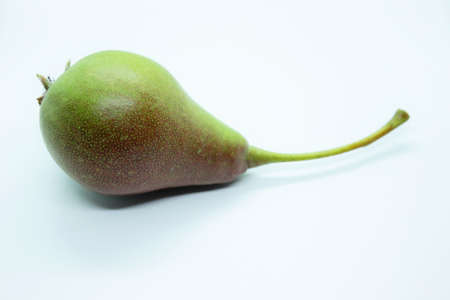 Green beautiful delicious pear is located on a white background