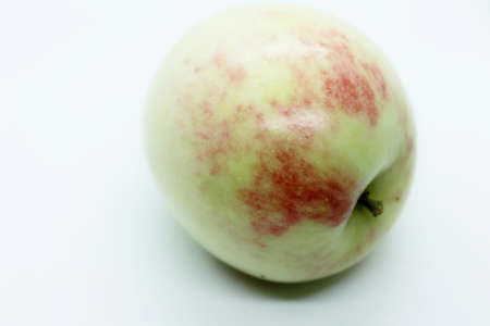 Green beautiful apple located on a white backgroundの写真素材