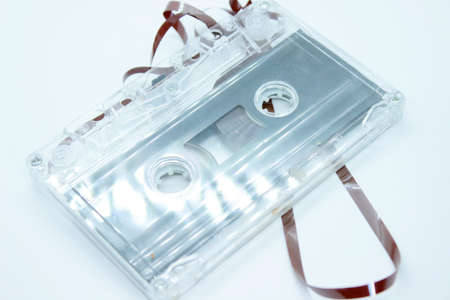 The old audio cassette is located on a white backgroundの写真素材