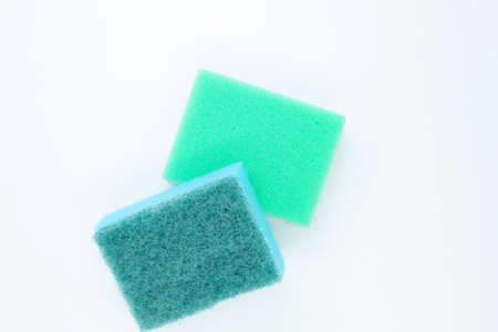 Multi-colored dishwashing sponges are placed on a white background