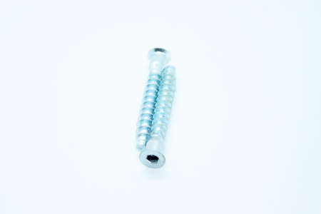 White metal screws located on a white background