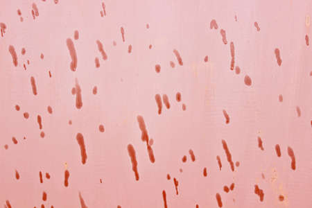 Background red painted surface with water dropletsの写真素材